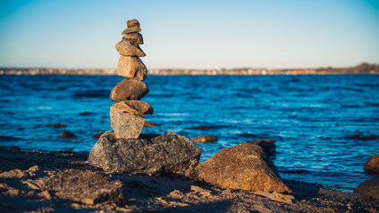 Stack of stones at the sea at sunset