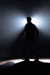 silhouette of a man in a spotlight