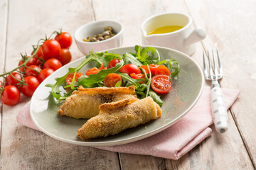 rolled sword fish with capers arugula and tomatoes salad