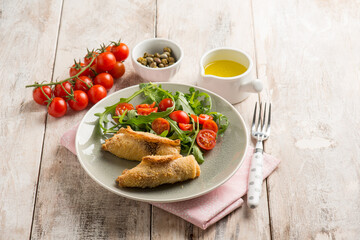 rolled sword fish with capers arugula and tomatoes salad
