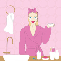 Beauty treatments. A smiling girl in a pink robe is standing in the bathroom. On the hair with a bandage. In the hands of a jar with patches. Next to the sink, cosmetics, bottles, soap.