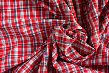 Cotton red tartan fabric texture. Crumpled