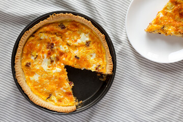 Homemade Bacon Quiche with Eggs and Cheddar Cheese, top view. Flat lay, overhead, from above.