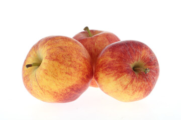whole and half red gala apple with green leaves isolated on white background