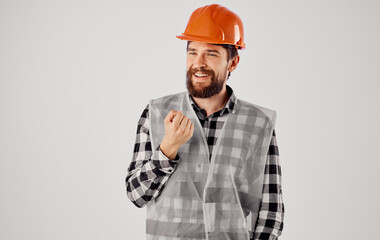 emotional builder in an orange hard hat and reflective pity on a light background