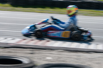 Unrecognised man driving Go-kart with speed in the on a karting track