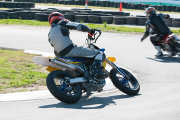 Obraz premium Unrecognized athlete riding a sports motorbike on a motocross racing