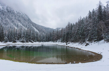 Amazing winter landscape with snowy mountains and clear waters of Green lake (Gruner see), famous tourist destination in Styria region, Austria