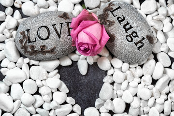 Valentine's Day. Stones with text and pink rose. Pattern of stones in the shape of a heart. Love,...