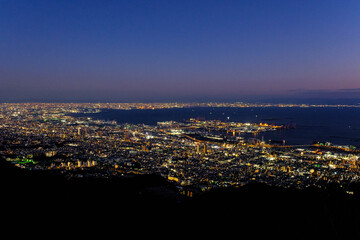 Fototapeta na wymiar 神戸摩耶山、掬星台からの夜景。遠く大阪湾をのぞむ