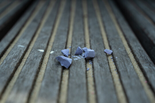 shards of pink purple chalk on the boards 