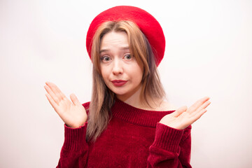 Young beautiful girl in a red beret isolated on a white background