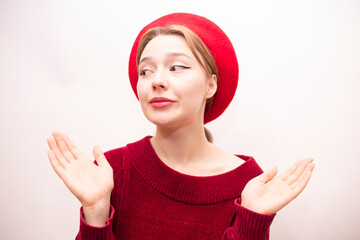 Young beautiful girl in a red beret isolated on a white background