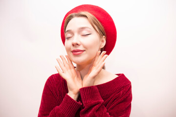 Young beautiful girl in a red beret isolated on a white background