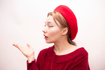 Young beautiful girl in a red beret isolated on a white background