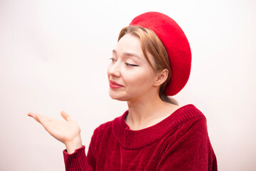 Young beautiful girl in a red beret isolated on a white background