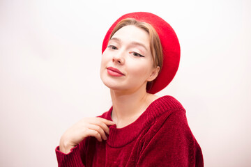 Young beautiful girl in a red beret isolated on a white background