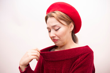 Young beautiful girl in a red beret isolated on a white background