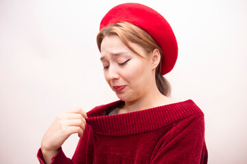Young beautiful girl in a red beret isolated on a white background