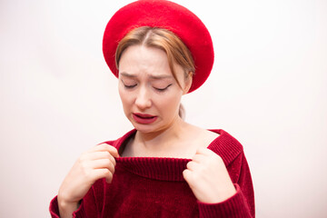 Young beautiful girl in a red beret isolated on a white background