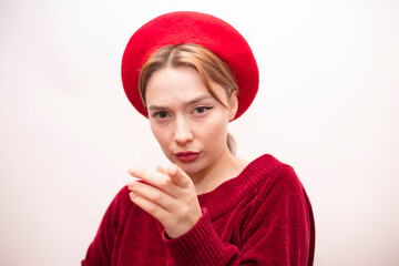 Young beautiful girl in a red beret isolated on a white background