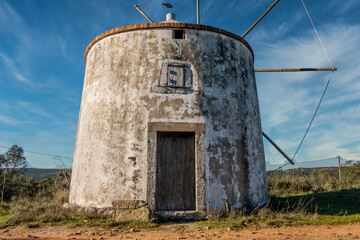 Old windmill in the middle of the mountain forest. Portuguese windmills called Moinhos da Pena