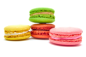 Delicious multicolored macaroons on white background.
