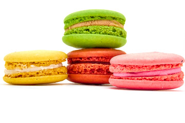 Delicious multicolored macaroons on white background.