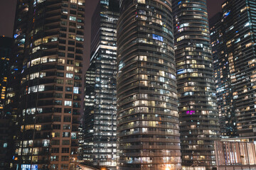 Fototapeta na wymiar Urban Night Cityscape View with Dense Apartment Buildings in a Metropolitan City for a Futuristic Feel