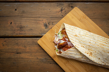 Durum Kebab at a local street food stall on wooden cutting board