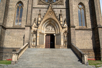 Obraz premium Entrance of a church in Prague with hard stone stairs and limestone ornaments.