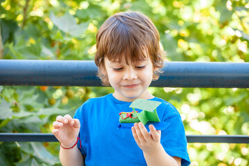 portrait of a little boy with a toy in his hands
