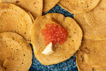 Above view of tasty pancakes with red caviar