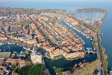 Obraz premium Aerial drone photo of the beautiful historic city of Enkhuizen, with old town marina harbors in the Netherlands