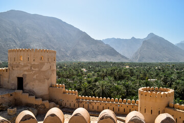 Date palms and mountains outside the walls of Nakhal Fort. Nakhal, Oman.