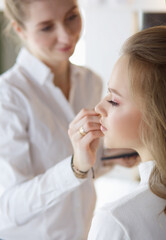 Obraz na płótnie Canvas beautiful young model woman getting fashion make-up