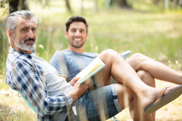 man and son relaxing outdoors