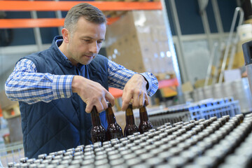 a brewery worker lifting bottles