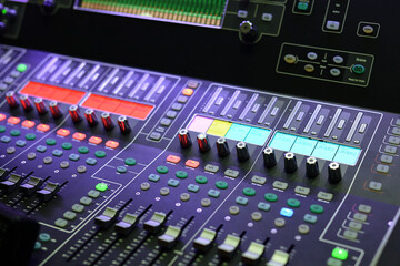 Sound engineer mixing console at work.