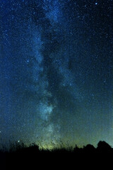 Vertical photo of clear night sky with milky way and huge amount of stars.