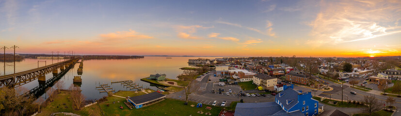 Aerial sunset panorama of Havre de Grace Maryland with orange sky and clouds reflecting on the...