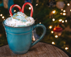 Christmas Hot Chocolate with Candy Canes by the Christmas Tree