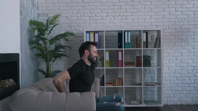 man felt back pain getting up from the couch