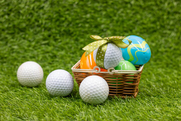 Golf ball for Easter Holiday with Easter Eggs on green grass