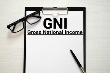 GNI Gross National Income written in a notebook on white table