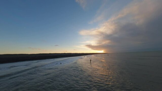 A beautiful aerial shot of the whole shoreline with surfers in Domburg, the Netherlands