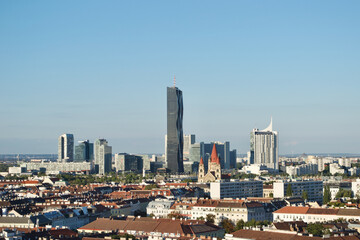 Obraz premium Old and new buildings in Vienna (Wien), Austria. A cityscape combining classical and contemporary metropolitan architecture, including Hochhaus Neue Donau, and the St. Francis of Assisi Church 
