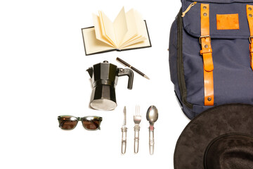 Simple camping kit for hiking in the mountains, including a blue backpack with leather straps, a camera, sunglasses, spoons, a notebook and pen, a hat, on a white background 2