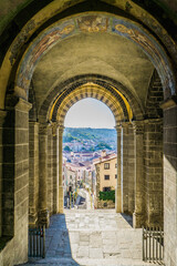 View from the main door of the Cathedral of Our Lady of the Annunciation or Cathedrale Notre-Dame du Puy on the medieval streets of the old town of Le Puy en Velay, Auvergne, France