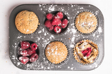 raspberry muffins on an oven tray